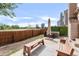 Spacious backyard patio with a bench, hot tub, and a privacy fence offering relaxation at 4534 Nepal St, Denver, CO 80249