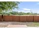 Large backyard with a wood fence and a bench, providing privacy and seating space at 4534 Nepal St, Denver, CO 80249