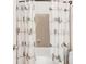Bathroom with a playful bird-themed shower curtain and tiled shower for a cheery feel at 4534 Nepal St, Denver, CO 80249