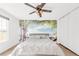 Bedroom featuring a ceiling fan and an accent wall with a palm tree design, creating a tropical feel at 4534 Nepal St, Denver, CO 80249