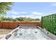 Inviting backyard hot tub, offering relaxation and privacy with surrounding fence and greenery at 4534 Nepal St, Denver, CO 80249