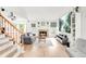 Bright living room featuring light wood floors, a cozy fireplace, and a comfortable gray sofa at 4534 Nepal St, Denver, CO 80249