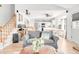 Open-concept living space featuring a sofa, staircase, and a modern kitchen in the background at 4534 Nepal St, Denver, CO 80249