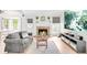 Inviting living room with a cozy brick fireplace, light wood floors, and a comfortable gray sofa at 4534 Nepal St, Denver, CO 80249