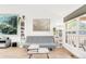Inviting living room featuring wood floors, a large window, and a comfortable gray sofa at 4534 Nepal St, Denver, CO 80249