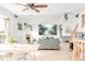 Bright living space showcasing a cozy fireplace, light wood floors, and comfortable gray sofas at 4534 Nepal St, Denver, CO 80249