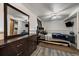 Bedroom with ceiling fan, accent wall, grey floors, dresser and TV at 18902 E 17Th Ave, Aurora, CO 80011