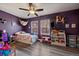 A colorful bedroom with hardwood floors, a ceiling fan, and playful decor at 18902 E 17Th Ave, Aurora, CO 80011
