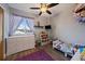 Bedroom featuring wood floor, ceiling fan, dresser, and single bed with toys at 18902 E 17Th Ave, Aurora, CO 80011