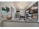 A bright, airy kitchen featuring stainless steel appliances and light granite countertops at 18902 E 17Th Ave, Aurora, CO 80011