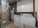 Laundry room features washer, dryer, cabinets, utility sink, and metal shelving at 18902 E 17Th Ave, Aurora, CO 80011
