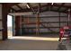 Large garage interior with a wooden staircase to the platform and an open door to the landscape at 2981 Rock Cir, Elizabeth, CO 80107