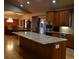 Spacious kitchen island with granite counters, wood floors, and stainless steel appliances at 2981 Rock Cir, Elizabeth, CO 80107