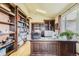 Home office with custom wood built-ins, a large desk, and ample natural light at 2981 Rock Cir, Elizabeth, CO 80107