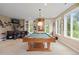 Finished basement boasting a pool table, custom bar, and ample natural light from large windows at 315 Prospect Dr, Castle Rock, CO 80108