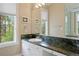 Bathroom with granite countertops, vanity, windows, and framed art at 315 Prospect Dr, Castle Rock, CO 80108