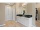 Bathroom with granite countertops, vanity, cabinet storage, and door to walk-in closet at 315 Prospect Dr, Castle Rock, CO 80108