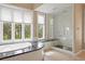 Elegant bathroom featuring a tub, walk-in shower, and large windows showcasing a serene wooded view at 315 Prospect Dr, Castle Rock, CO 80108