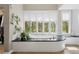 Modern soaking tub with black marble surround and many windows bringing the outdoors in at 315 Prospect Dr, Castle Rock, CO 80108
