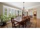 Dining room with large windows overlooking the lush surroundings and a long, wooden table at 315 Prospect Dr, Castle Rock, CO 80108