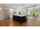 Modern kitchen with stainless steel appliances, an expansive island, and sunlit breakfast nook at 315 Prospect Dr, Castle Rock, CO 80108