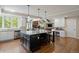 A bright kitchen with stainless steel appliances and a large island with barstool seating at 315 Prospect Dr, Castle Rock, CO 80108