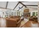 Open living space with a fireplace, beamed ceilings, and seamless access to the breakfast nook at 315 Prospect Dr, Castle Rock, CO 80108