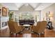 Elegant living room features vaulted ceilings, fireplace, hardwood floors, and a wall of windows with natural light at 315 Prospect Dr, Castle Rock, CO 80108