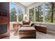 Cozy sitting area featuring an armchair, ottoman, and windows offering natural light and a serene view at 315 Prospect Dr, Castle Rock, CO 80108