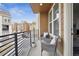 Relax on the covered balcony with seating and views of the surrounding neighborhood at 8331 Farmers Way, Highlands Ranch, CO 80129