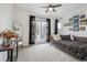 Bedroom with neutral carpet, mirror, dark curtains, and large window at 8331 Farmers Way, Highlands Ranch, CO 80129