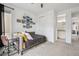 Bedroom features neutral carpet, desk, large window, and closet at 8331 Farmers Way, Highlands Ranch, CO 80129