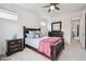 Bedroom with carpet, large window, full-sized bed, lamps, a dresser, and en-suite bathroom at 8331 Farmers Way, Highlands Ranch, CO 80129