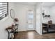 Bright foyer featuring hardwood floors, modern console table, and a stylishly framed mirror at 8331 Farmers Way, Highlands Ranch, CO 80129