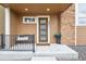 Inviting front porch featuring a cozy bench and a decorative succulent, enhancing curb appeal at 8331 Farmers Way, Highlands Ranch, CO 80129