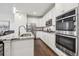 Contemporary kitchen featuring white cabinetry, granite countertops, and stainless steel appliances at 8331 Farmers Way, Highlands Ranch, CO 80129