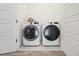 Well-lit laundry room showcasing a modern, front-load washer and dryer set at 8331 Farmers Way, Highlands Ranch, CO 80129