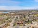 Aerial view of the neighborhood highlighting mature trees, the lake, and the mountains in the distance at 10978 W Ada Pl, Lakewood, CO 80226