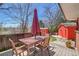 Inviting deck with a table, umbrella, and chairs, perfect for outdoor dining and relaxing at 10978 W Ada Pl, Lakewood, CO 80226