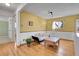 Cozy living room with hardwood floors, bright yellow walls, and a relaxing atmosphere at 10978 W Ada Pl, Lakewood, CO 80226