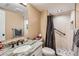 Modern bathroom features a granite countertop, a decorative mirror, and a tiled walk-in shower with grab bar at 5190 S Emporia Way, Greenwood Village, CO 80111