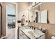 Bathroom featuring a granite countertop vanity, modern fixtures, and an open doorway to an adjacent room at 5190 S Emporia Way, Greenwood Village, CO 80111