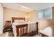 Cozy bedroom features a classic wooden bed frame with decorative pillows and natural light from the window at 5190 S Emporia Way, Greenwood Village, CO 80111
