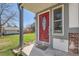 Inviting front entrance featuring a striking red door with decorative glass and a well-kept front lawn at 5190 S Emporia Way, Greenwood Village, CO 80111