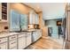 Kitchen showcases modern appliances, granite counters, and a view of the staircase to the living room at 5190 S Emporia Way, Greenwood Village, CO 80111