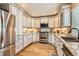 Bright kitchen featuring stainless steel appliances, light cabinetry, and granite countertops at 5190 S Emporia Way, Greenwood Village, CO 80111