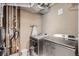 Well-equipped laundry area with modern washer and dryer, plus exposed copper pipes for a unique design at 5190 S Emporia Way, Greenwood Village, CO 80111