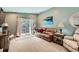 Living room with sliding glass doors, comfortable seating, and natural lighting at 5190 S Emporia Way, Greenwood Village, CO 80111