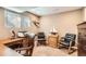 Home office boasts wooden desk, executive chair, and decor, providing a dedicated space for work at 5190 S Emporia Way, Greenwood Village, CO 80111