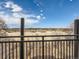 Balcony view of trees and buildings on the horizon, viewed from behind a black metal balcony railing at 5995 W Hampden Ave # 23, Denver, CO 80227
